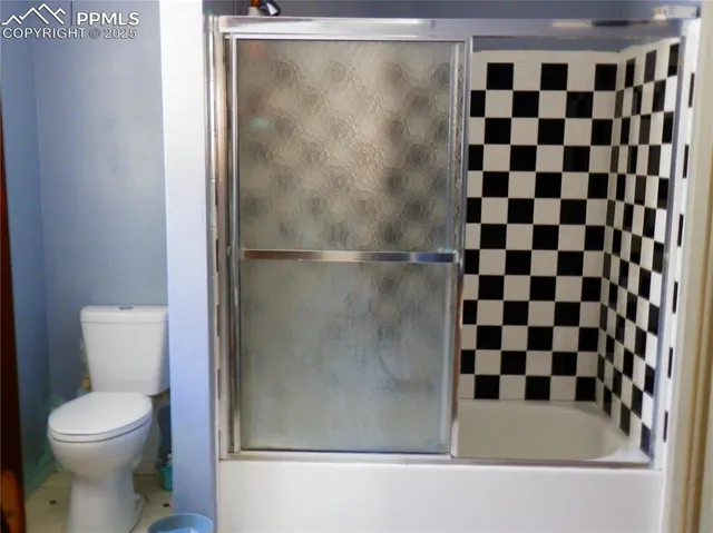 a bathroom with a toilet a sink and a mirror