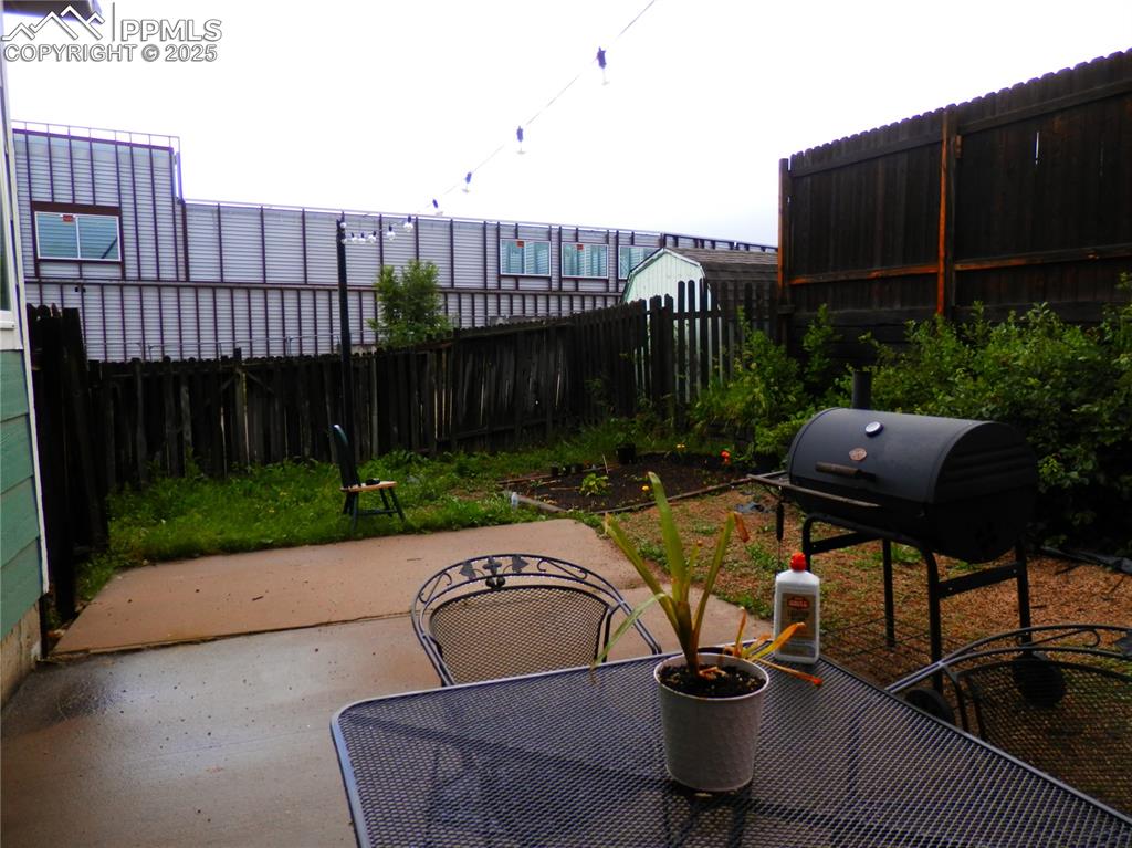 4450 Chaparral Road Colorado Springs, CO 80917 - Photo 4 of 29 a backyard of a house with table and chairs