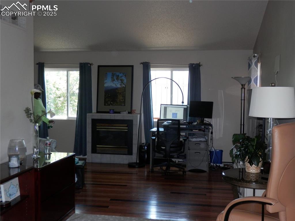 4450 Chaparral Road Colorado Springs, CO 80917 - Photo 7 of 29 a workspace with furniture window and wooden floor