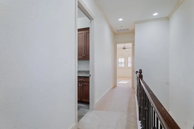 a view of hallway with stairs and wooden floor