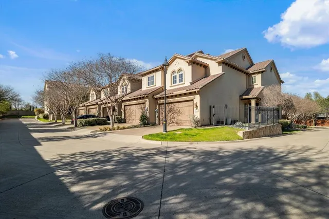 a view of a white house with a swimming pool and a yard