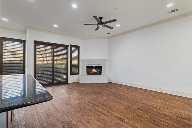a view of an empty room with a window and a fireplace