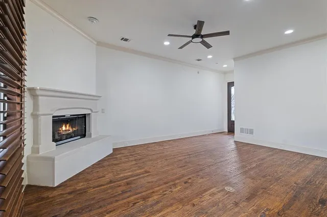 wooden floor in an empty room with a fireplace
