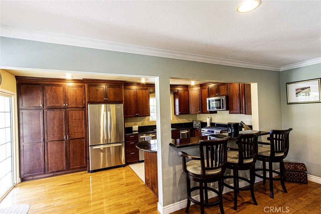 1830 Hawkbrook Drive San Dimas, CA 91773 - Photo 10 of 21 a kitchen with stainless steel appliances a refrigerator and a stove top oven
