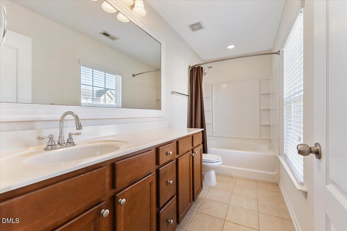 4440 Cardinal Grove Boulevard Raleigh, NC 27616 - Photo 21 of 42 a bathroom with a sink a toilet and shower