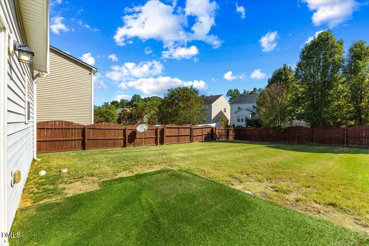 4440 Cardinal Grove Boulevard Raleigh, NC 27616 - Photo 32 of 42 a view of a backyard with grass and a tree