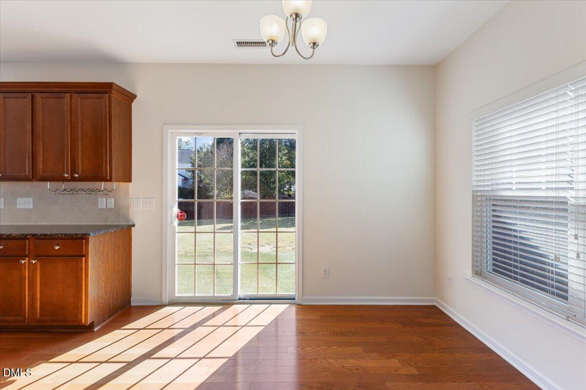 4440 Cardinal Grove Boulevard Raleigh, NC 27616 - Photo 5 of 42 a view of an empty room with wooden floor and a window
