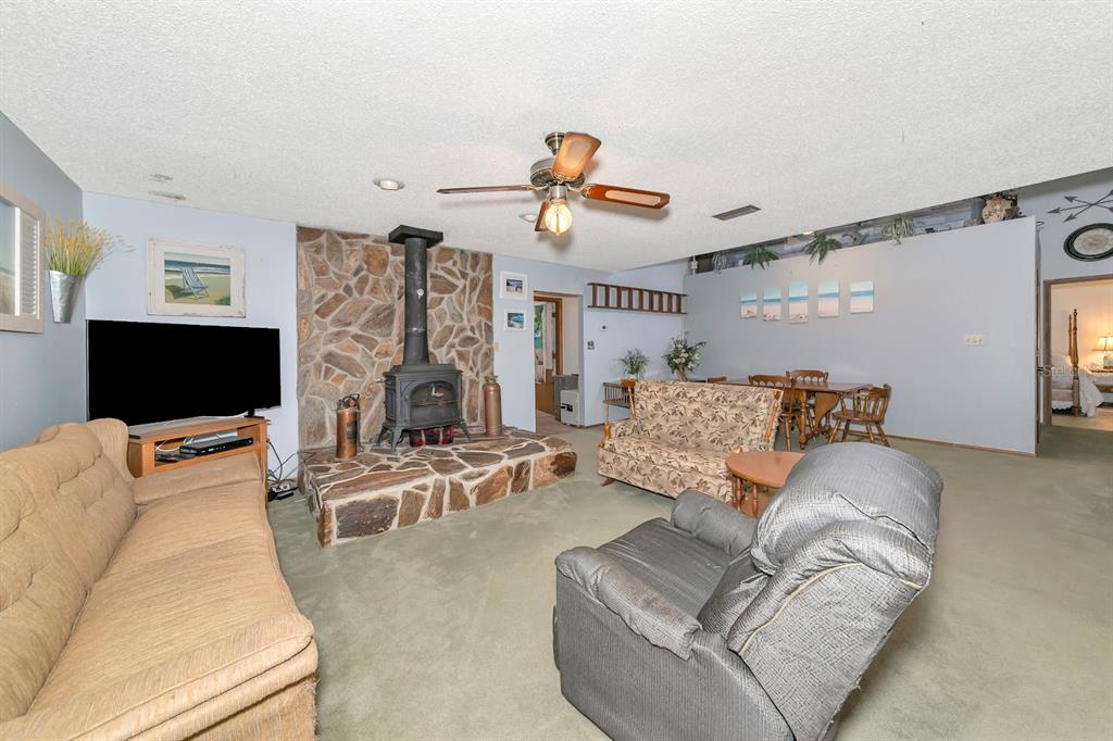 2070 59th Street Sarasota, FL 34243 - Photo 14 of 56 a living room with furniture a flat screen tv and a fireplace