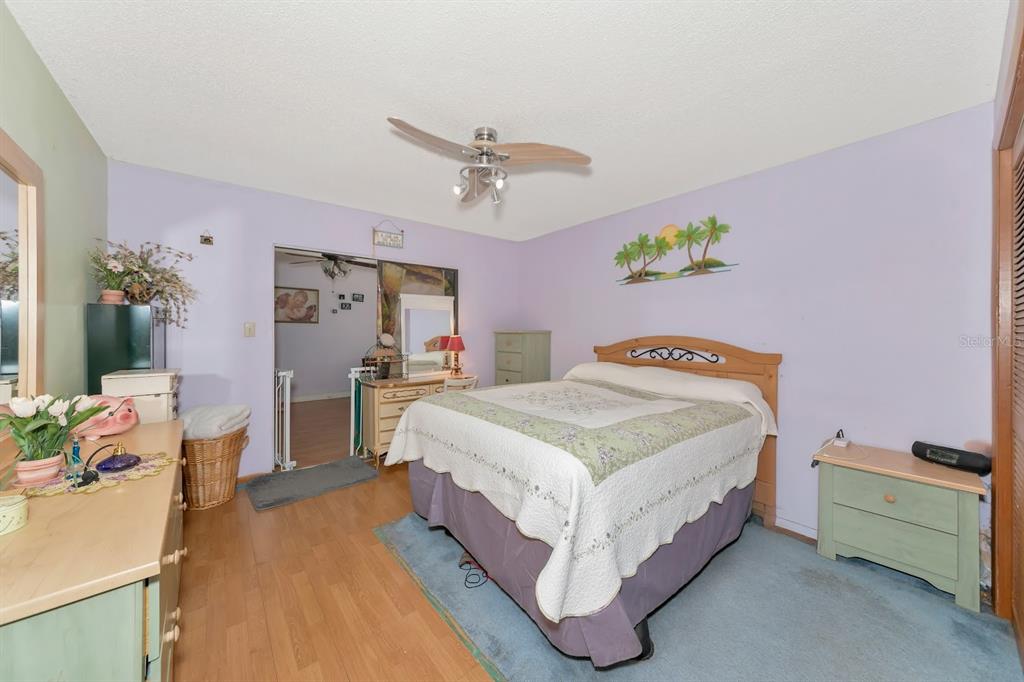 2070 59th Street Sarasota, FL 34243 - Photo 18 of 56 a spacious bedroom with a bed and a table