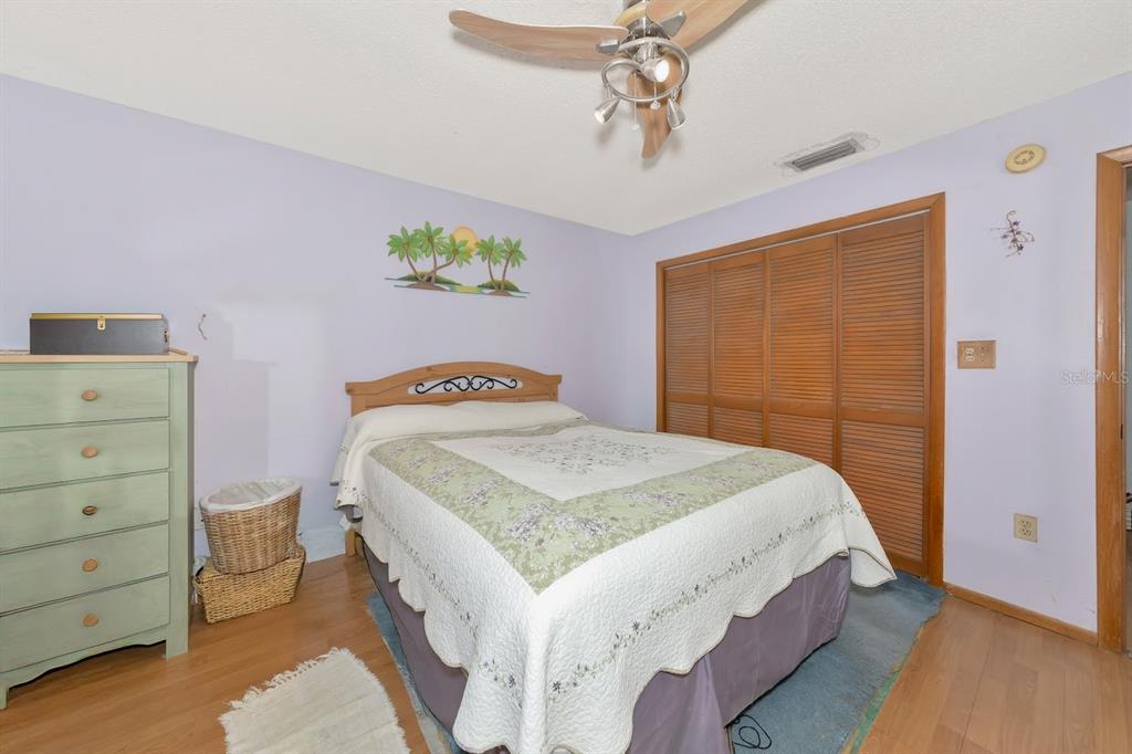 2070 59th Street Sarasota, FL 34243 - Photo 19 of 56 a bedroom with a bed and a dresser