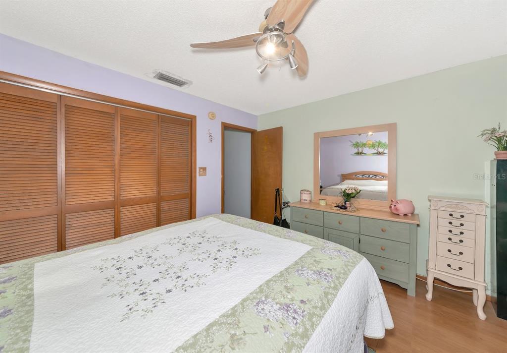 2070 59th Street Sarasota, FL 34243 - Photo 20 of 56 a bedroom with a bed and a dresser