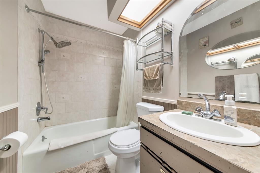 2070 59th Street Sarasota, FL 34243 - Photo 24 of 56 a bathroom with a sink a toilet and a bathtub