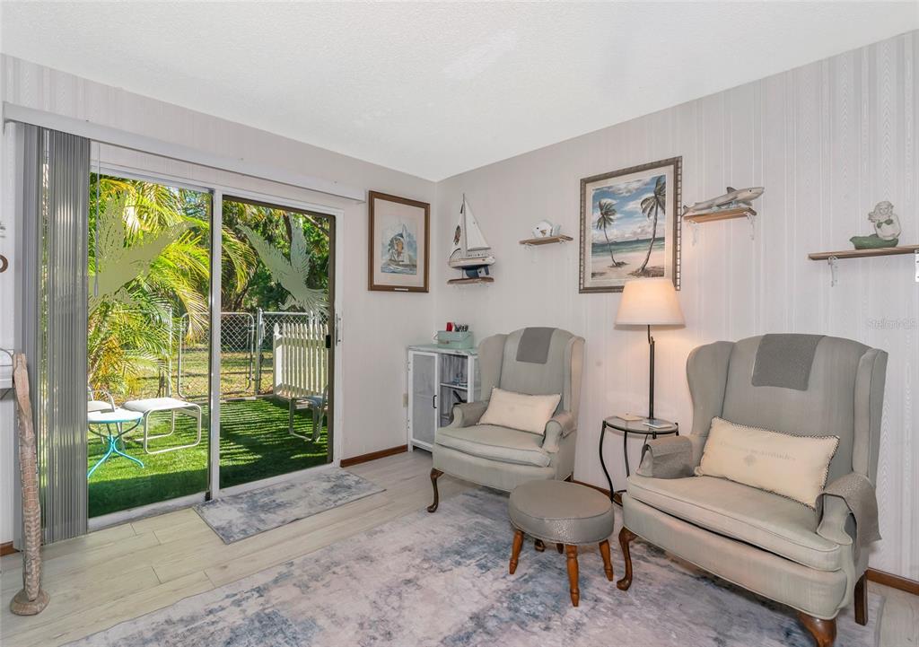 2070 59th Street Sarasota, FL 34243 - Photo 26 of 56 a living room with furniture and a floor to ceiling window
