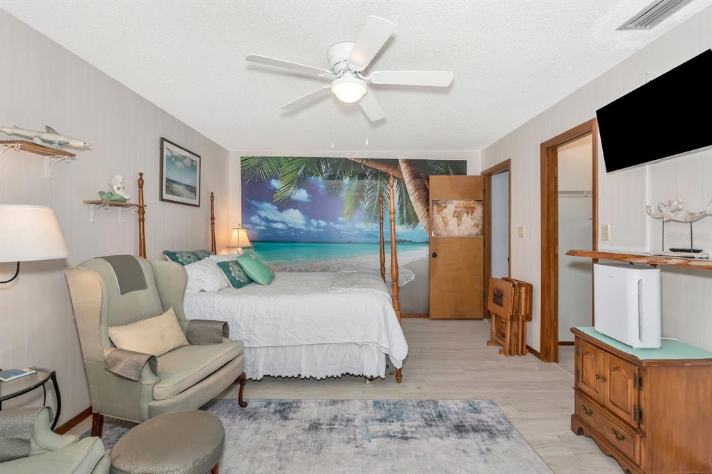2070 59th Street Sarasota, FL 34243 - Photo 29 of 56 a bedroom with a large bed and a flat screen tv