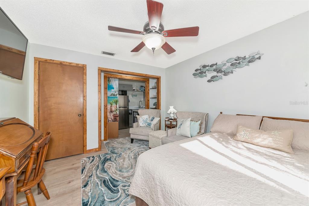 2070 59th Street Sarasota, FL 34243 - Photo 34 of 56 a bedroom with a bed and a chandelier