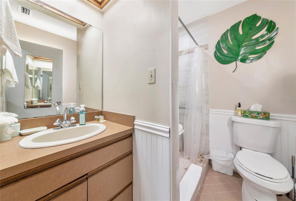 2070 59th Street Sarasota, FL 34243 - Photo 38 of 56 a bathroom with a sink a toilet and a mirror