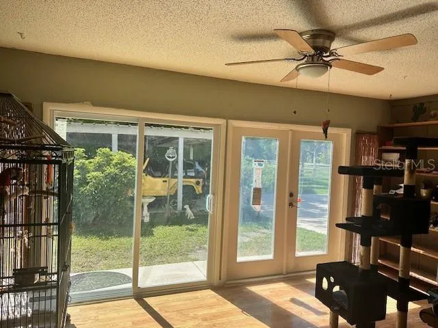 a living room with patio furniture and a large window
