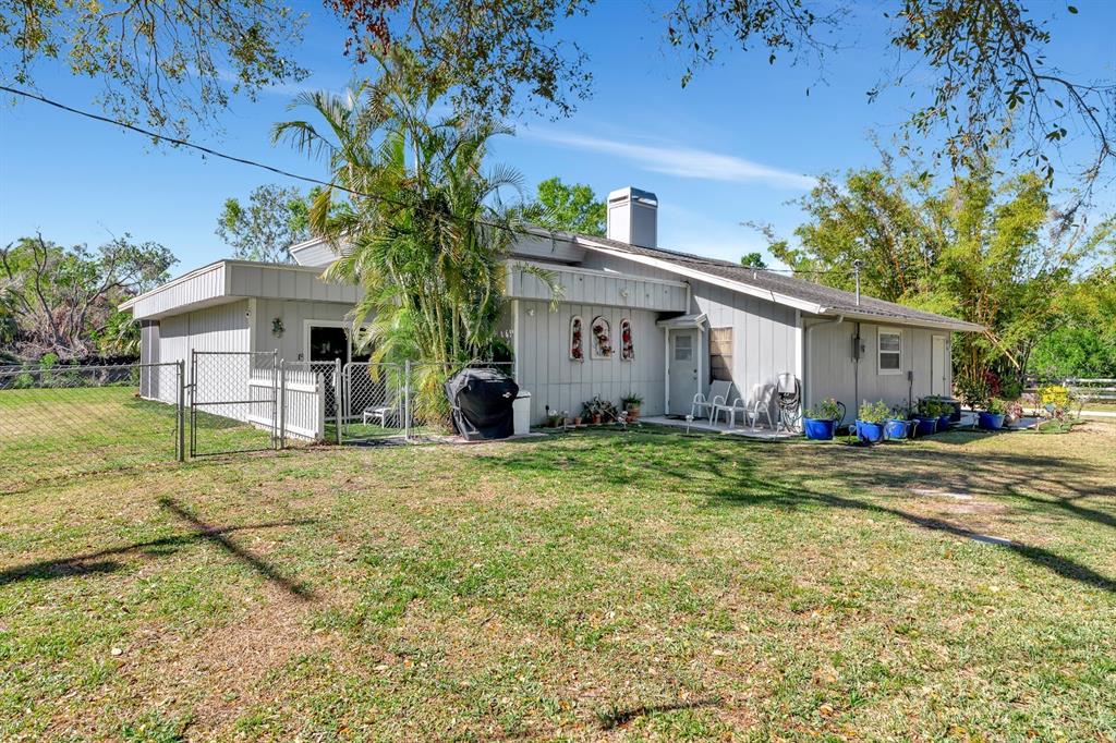 2070 59th Street Sarasota, FL 34243 - Photo 41 of 56 a view of a house with backyard and a tree