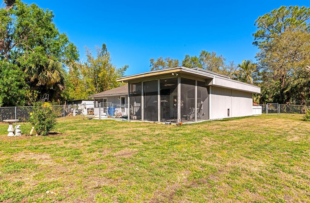 2070 59th Street Sarasota, FL 34243 - Photo 52 of 56 a front view of a house with a garden