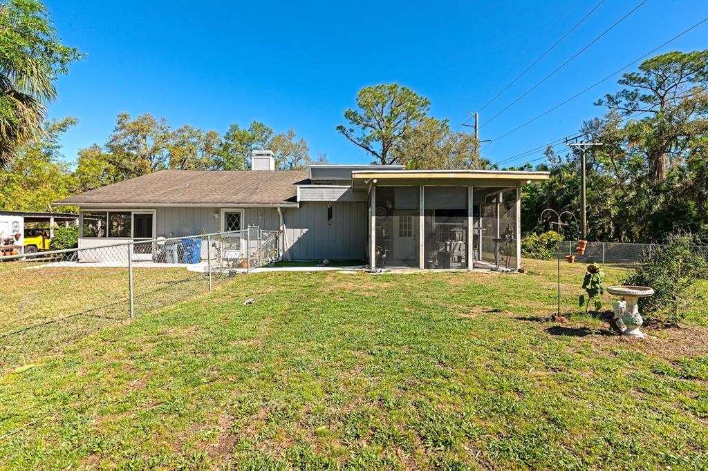 2070 59th Street Sarasota, FL 34243 - Photo 53 of 56 a front view of a house with a garden