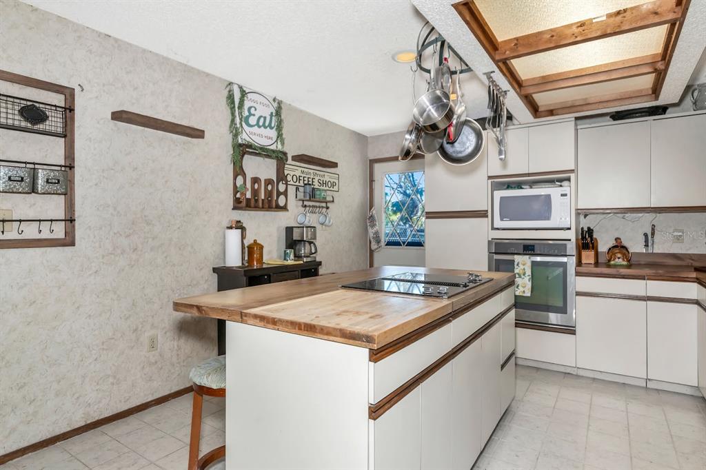 2070 59th Street Sarasota, FL 34243 - Photo 7 of 56 a kitchen with stainless steel appliances granite countertop a sink and cabinets