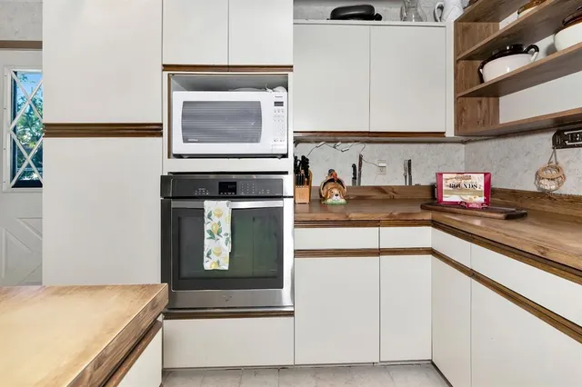 a kitchen with stainless steel appliances granite countertop a sink and a stove