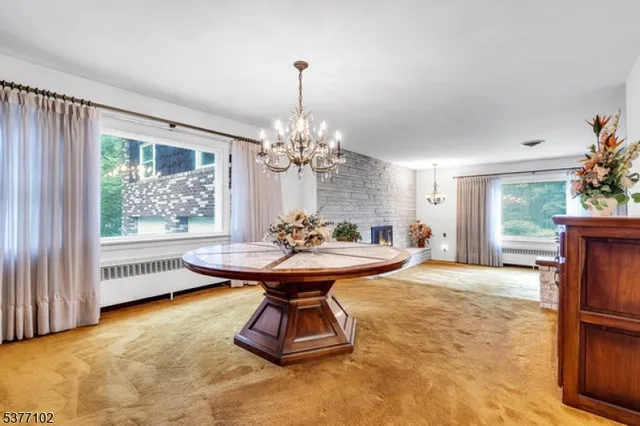 a view of a livingroom with a space a ceiling fan and window