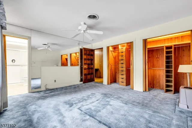 a large bed in a room with a large window