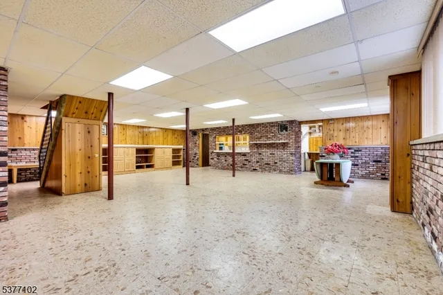 a bathroom with a granite countertop toilet sink and mirror
