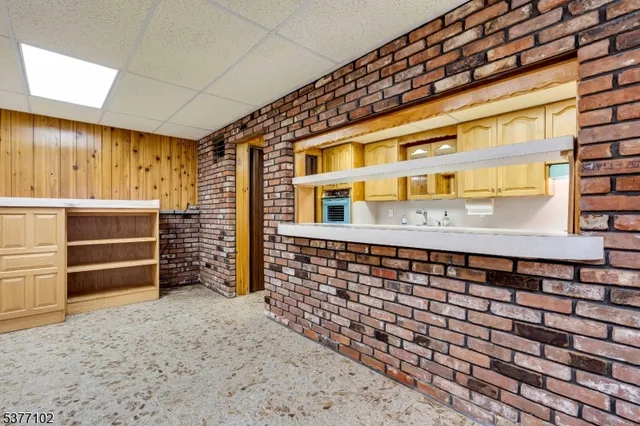 a kitchen with stainless steel appliances granite countertop a sink and a refrigerator