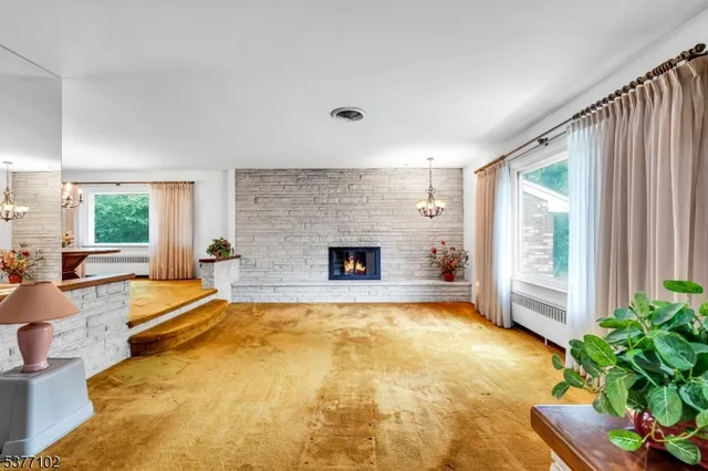 a view of an empty room with a fireplace
