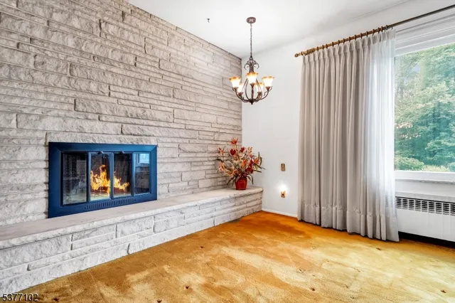 a view of a dining room with furniture and chandelier