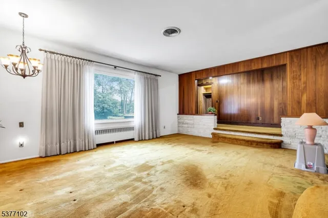 a front view of a house with basket ball court and a window