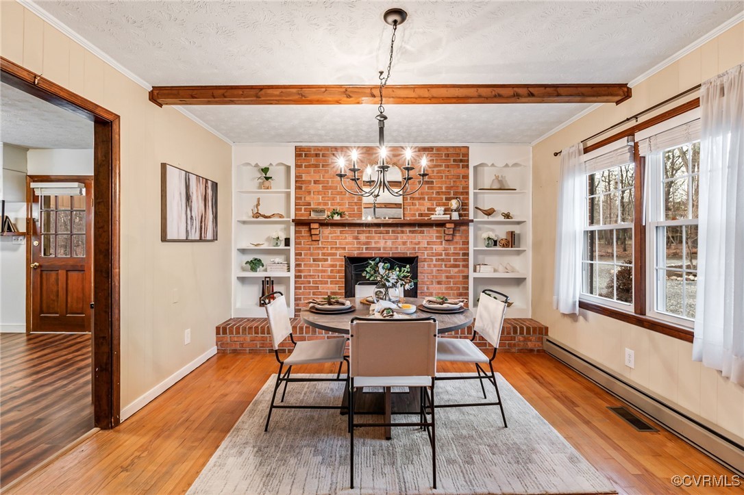 8087 Bell Road Dillwyn, VA 23936 - Photo 11 of 37 a dining room with furniture a chandelier and wooden floor