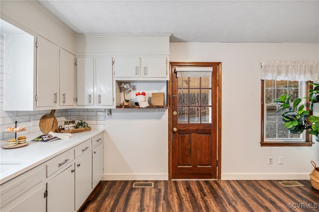 8087 Bell Road Dillwyn, VA 23936 - Photo 15 of 37 a kitchen with white cabinets and wooden floor