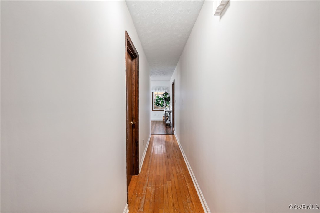 8087 Bell Road Dillwyn, VA 23936 - Photo 17 of 37 a view of a hallway with wooden floor