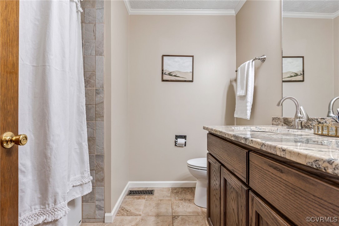 8087 Bell Road Dillwyn, VA 23936 - Photo 22 of 37 a bathroom with a granite countertop sink toilet and shower