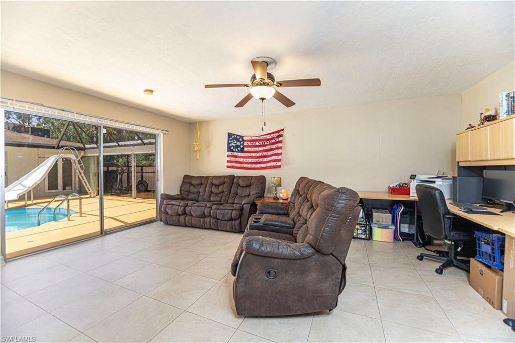 339 Delaware Road Lehigh Acres, FL 33936 - Photo 11 of 30 a living room with furniture and a flat screen tv