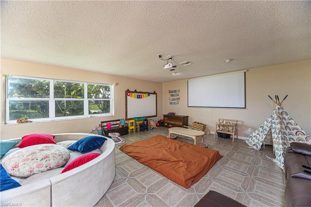 339 Delaware Road Lehigh Acres, FL 33936 - Photo 14 of 30 a living room with furniture and window