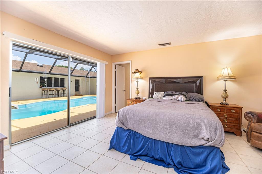 339 Delaware Road Lehigh Acres, FL 33936 - Photo 19 of 30 a bedroom with a bed and a ceiling fan