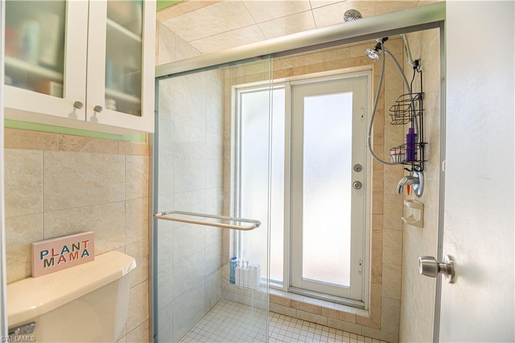 339 Delaware Road Lehigh Acres, FL 33936 - Photo 21 of 30 a view of a bathroom with a shower and a sink