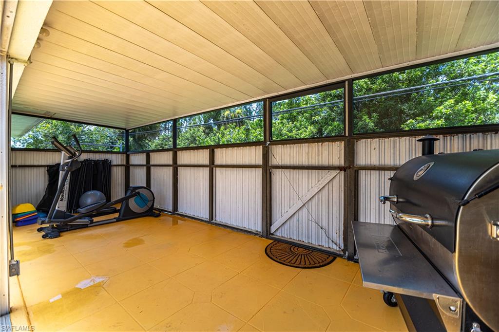 339 Delaware Road Lehigh Acres, FL 33936 - Photo 23 of 30 a view of a room with gym equipment and a large window