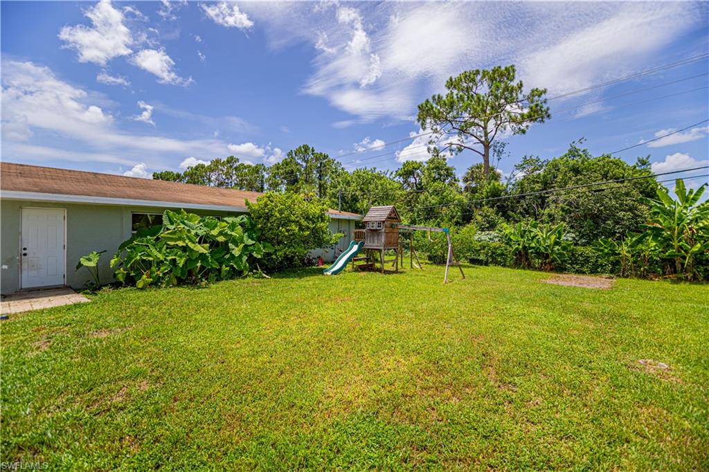 339 Delaware Road Lehigh Acres, FL 33936 - Photo 24 of 30 a view of a yard with an tree