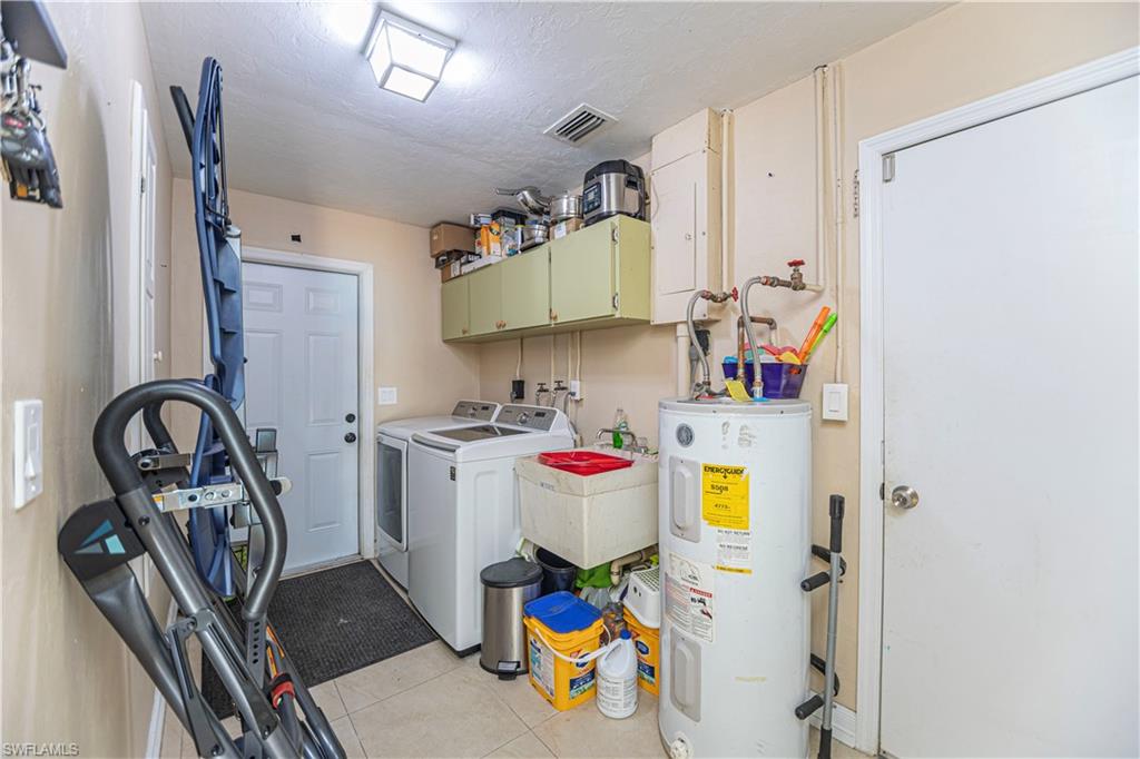 339 Delaware Road Lehigh Acres, FL 33936 - Photo 25 of 30 a view of a kitchen with appliances and cabinets