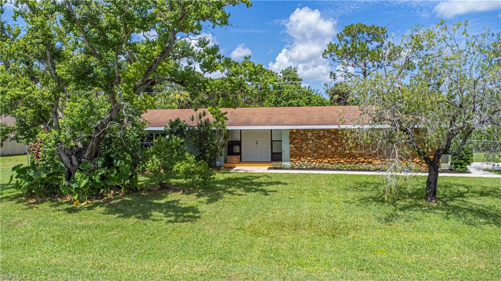 339 Delaware Road Lehigh Acres, FL 33936 - Photo 27 of 30 a view of house with a yard