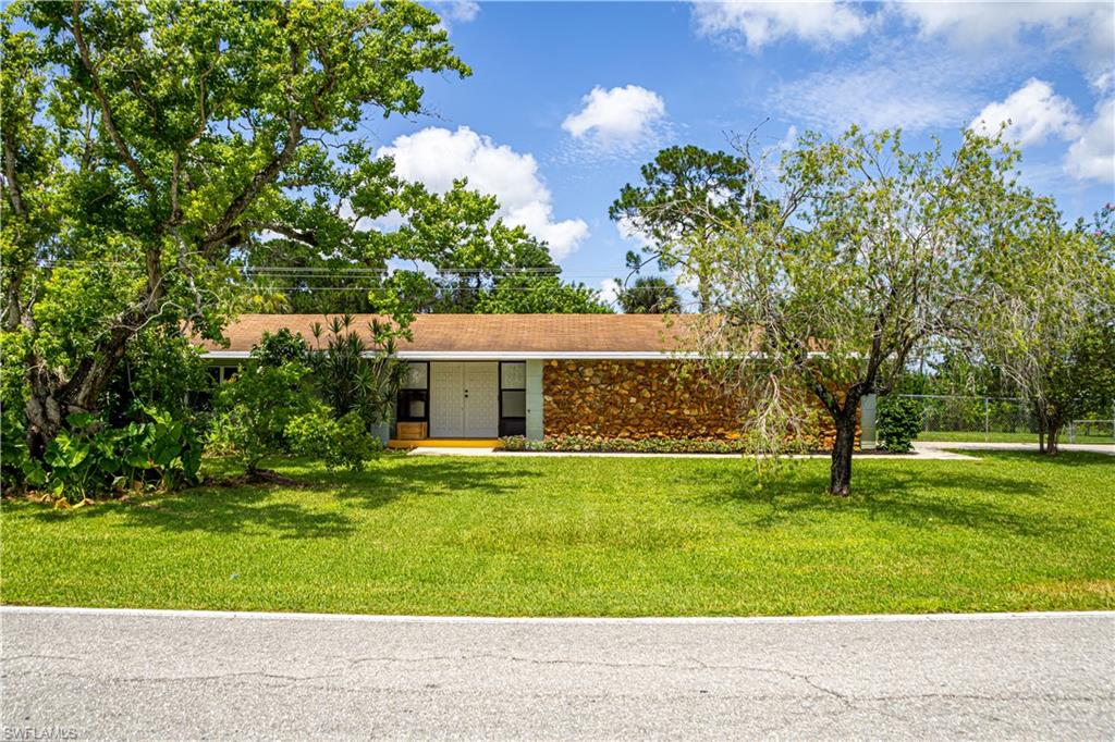 339 Delaware Road Lehigh Acres, FL 33936 - Photo 3 of 30 a front view of a house with a yard