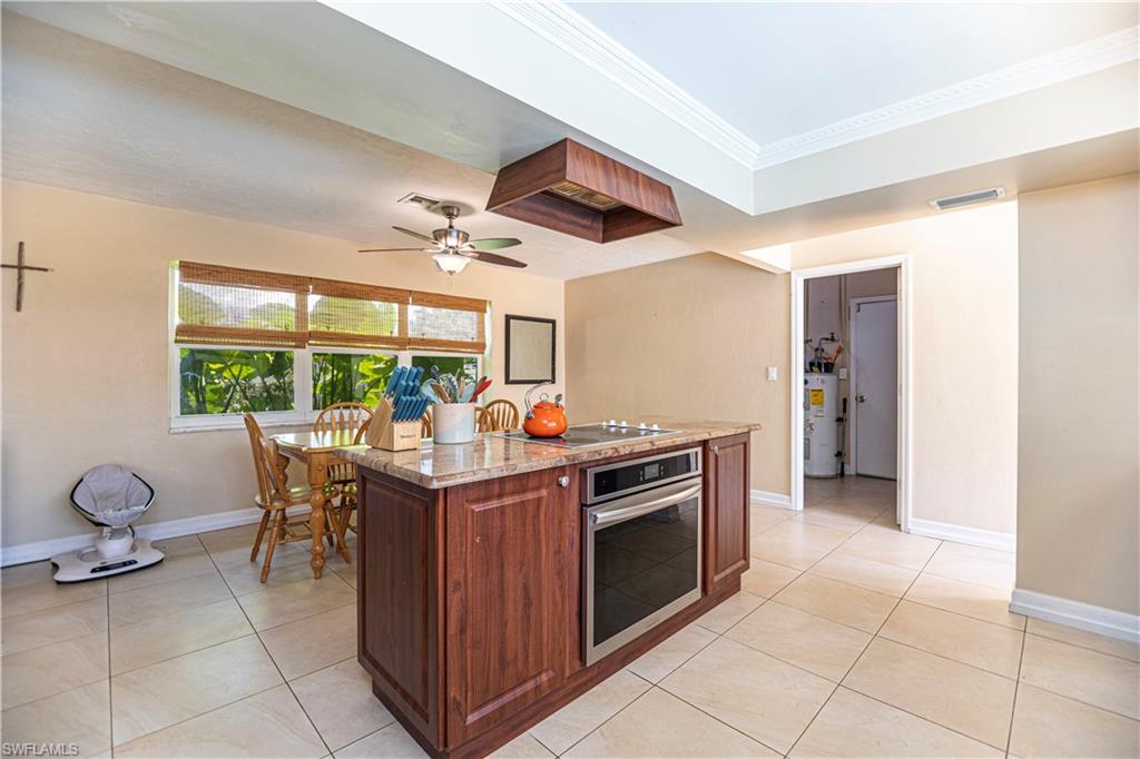 339 Delaware Road Lehigh Acres, FL 33936 - Photo 8 of 30 a kitchen that has a stove and a microwave