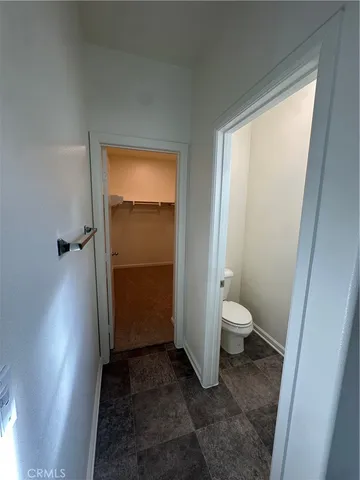 a bathroom with a granite countertop toilet and a shower