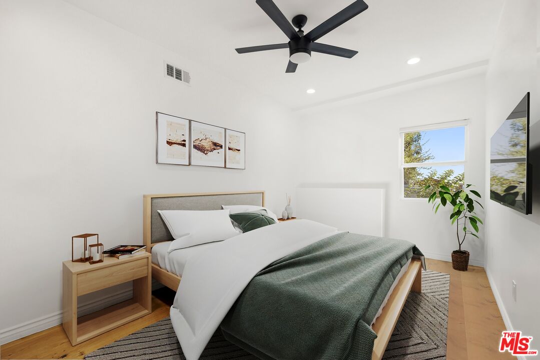 1788 North Orange Grove Avenue Los Angeles, CA 90046 - Photo 11 of 20 a bedroom with a bed and a flat screen tv