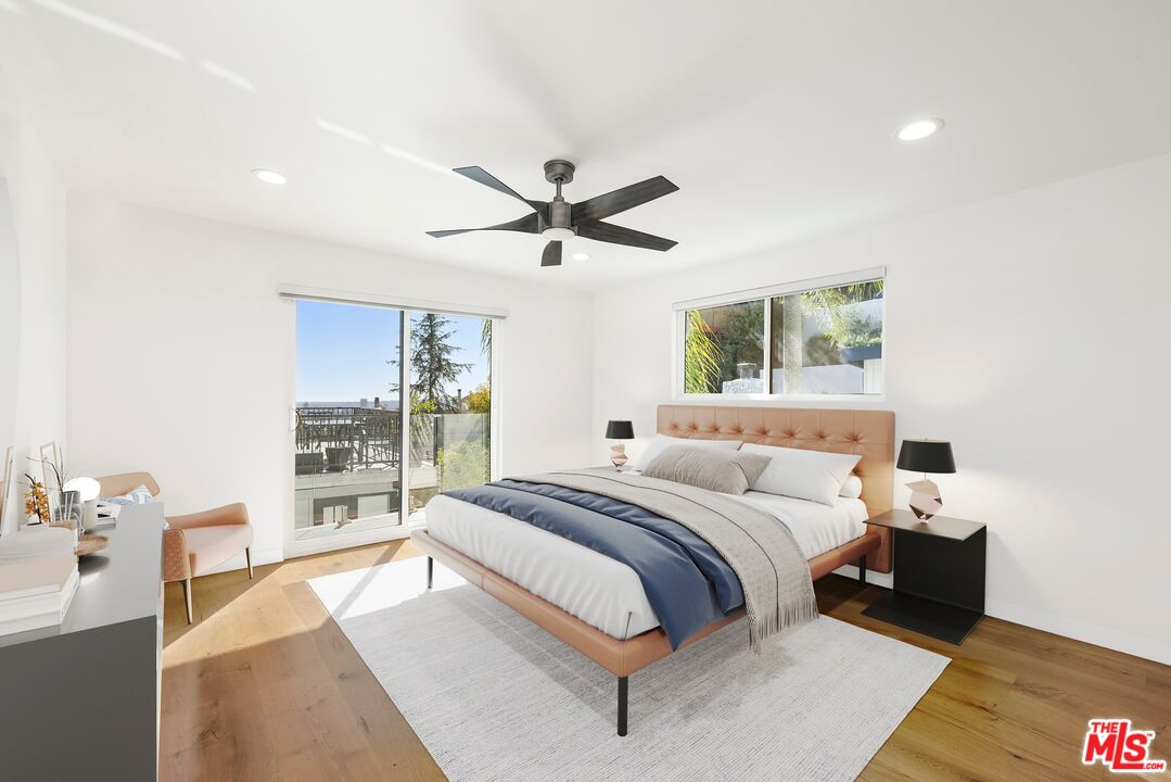 1788 North Orange Grove Avenue Los Angeles, CA 90046 - Photo 12 of 20 a bedroom with a large bed and a large window